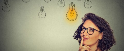Businesswoman with a lightbulb over her head conceptual image of rethinking document strategy
