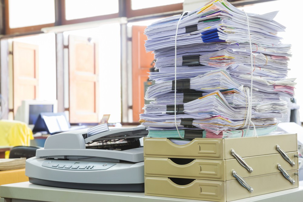 Stack of papers representing scanning options and benefits for large volumes