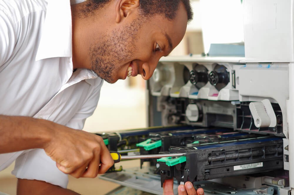 Close up of a service technician doing copier repair