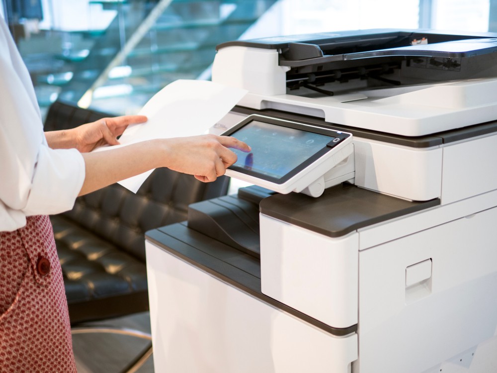 close up of a professional woman interacting with a business copier's interface