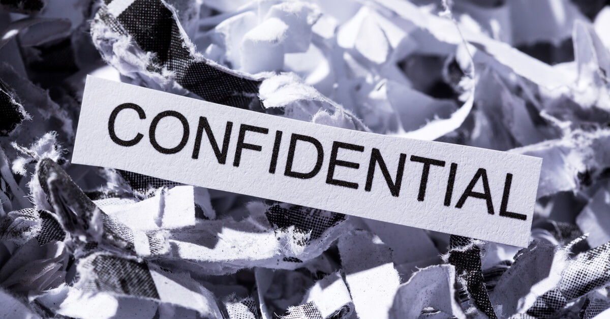 Shredded pile of paper with the word confidential in the center