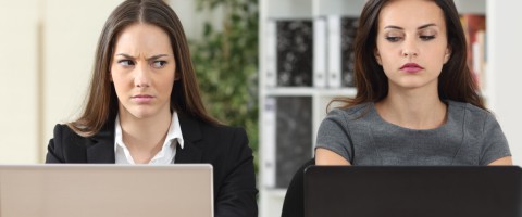 woman looking at another woman's laptop computer