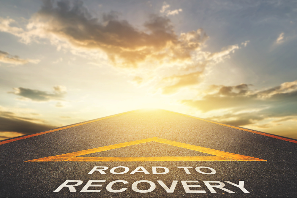 An image of a road ahead with an arrow and the text Disaster Recovery pointing a way forward.